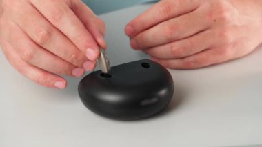 Hastanın işitme cihazını dahili güç bankası olan özel taşınabilir Smart Charger ile şarj etmesi. İşitme cihazını masaüstü şarj makinesine yerleştir