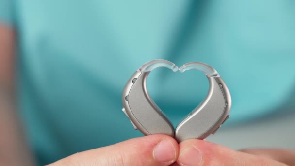 Hearing Aids Hands Making Heart Shape Blue Background Closeup Listening — Stock Video
