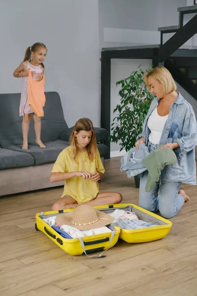 Mother Daughters Packing Yellow Suitcase Travel Family Collecting Clothes Accessories — Stock Photo, Image
