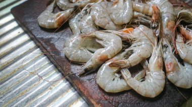 Kesme tahtasından taze karides temizlendi. Çiğ karides sağlıklı deniz ürünüdür.