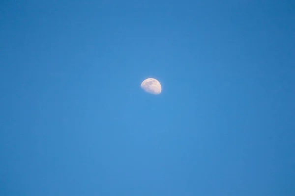 half moon in the blue sky
