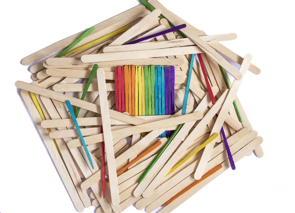 multicolored LGTBIQA+ flag made of wooden sticks sticking out of a crowd of wooden sticks, concept of living in a society with equal opportunities regardless of sexual orientation