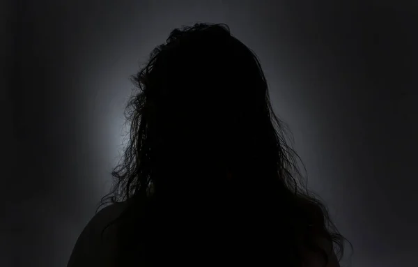 silhouette of woman, head and long hair in black and White