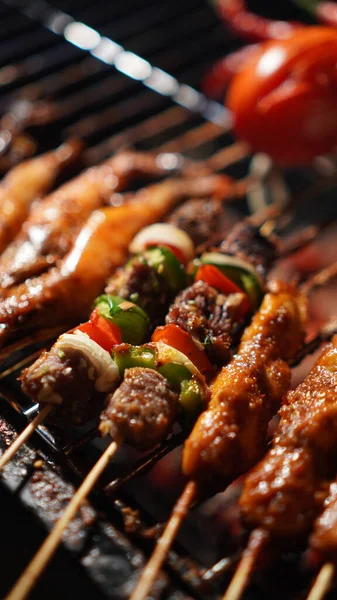 stock image Grilled various food, chicken, beef, seafood, prawn, squid, satay and vegetable and meat skewers with herbs on a charcoal traditional iron grill, top view, selective focus