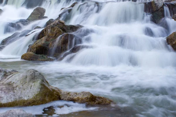 Long exposure of waterfall with rocks in Serpis river, Lorcha, Spain