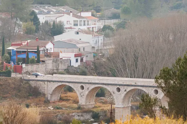 Winter landscape with bridge over the Serpis river that gives access to the town of Lorcha, Spain