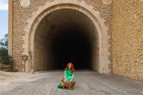 With the dog Nami in the access tunnel to the madorio dam in Orxeta, Spain