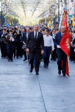 04-19-2024: Music band parading with its director in front at the pasodoble festival prior to singing the festival anthem of Alcoy, Spain clipart