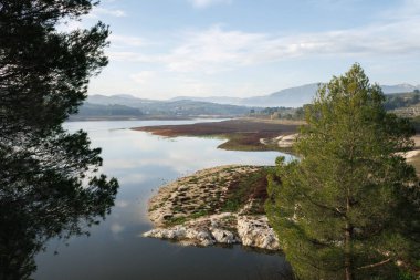 Landscape of the Beniarres reservoir with low water level due to climate change, Spain clipart