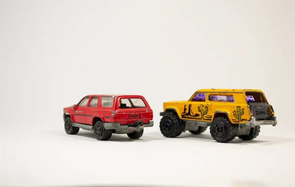 two Sport Utility Vehicle toy car red and yellow color on white background