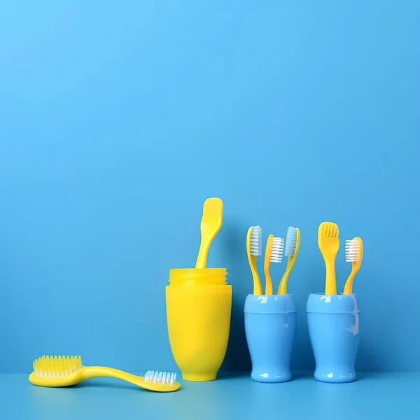 toothbrushes on a blue background. top view of a wooden toothbrush on a yellow and white table. space