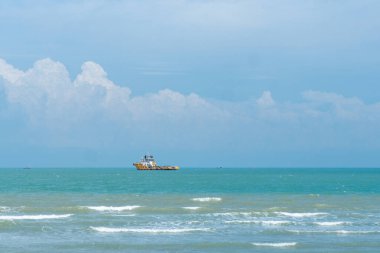 Endonezya, Tuban 'da açık bir gündüz vakti gökyüzü altında çarpıcı kayalık çıkıntıları olan canlı mavi okyanus.