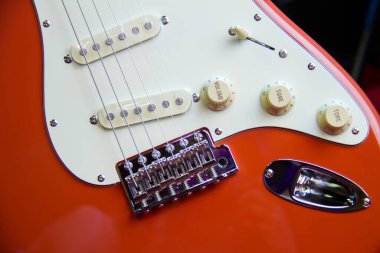 Tek sarmalı, beyaz yankesicisi ve gümüş donanımlı sağlam bir fiesta kırmızı elektro gitarı kapatın..