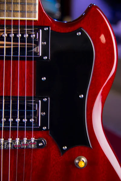 バッカーピックアップ ブラックピックアップガード シルバーハードウェアとソリッドレッド電気ギターのクローズアップ — ストック写真
