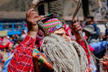 Geleneksel kostümlü dansçılar ve kalabalık Virgen del Carmen 'in şenliğini koreografilerle kutluyorlar. Temmuz 2023, Paucartambo. Cusco Peru.