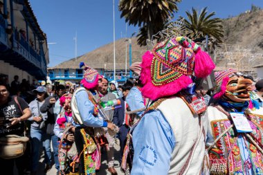 Geleneksel kostümlü dansçılar ve kalabalık Virgen del Carmen 'in şenliğini koreografilerle kutluyorlar. Temmuz 2023, Paucartambo. Cusco Peru.