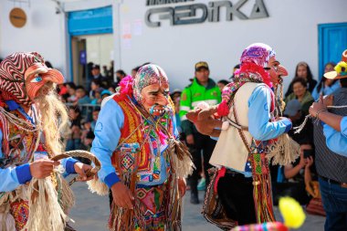 Geleneksel kostümlü dansçılar ve kalabalık Virgen del Carmen 'in şenliğini koreografilerle kutluyorlar. Temmuz 2023, Paucartambo. Cusco Peru.