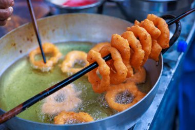 Peruvian Picarones, a delicious dessert made of wheat flour mixed with pumpkin and, sometimes, sweet potato, bathed in chancaca honey. It is a traditional dish of Peruvian gastronomy. clipart