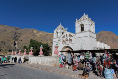 Turistler Colca Vadisi 'ndeki Akbaba' nın bakış açısını ziyaret ediyorlar. Maca meydanında el işi ve alpaka satıyorum. Arequipa Peru