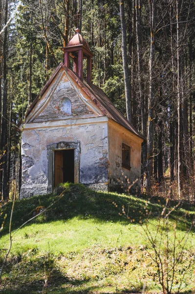 stock image Exterior of an abandoned chapel in the woods. Daytime. Summer.