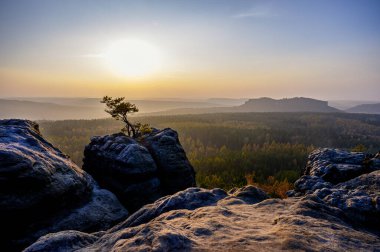 view from gohrisch in the saxon switzerland during autumn sunrise, germany clipart