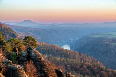 Beatiful autumn sunset. The Schrammsteine Rocks of Saxon Switzerland, Bad Schandau, Germany clipart