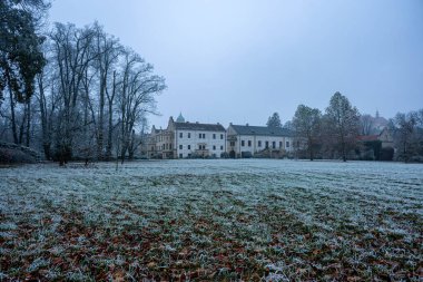 Castolovice, Czech republic -October 11, 2024: Renaissance castle in Castolovice, Czech Republic, first snow around the castle and in the park clipart