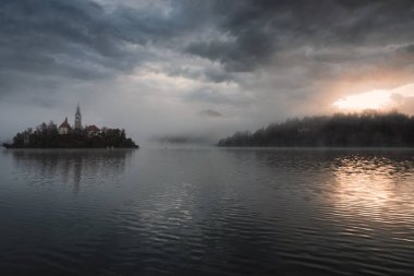 Misty morning in lake Bled and famous island with old church-Slovenia clipart