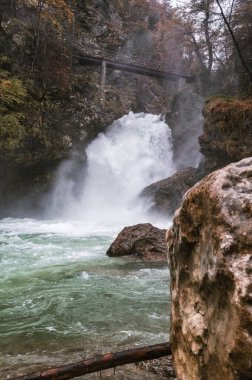 Picturesque Sum waterfall at autumn flood on Radovna river in the end of Vintgar gorge, Slovenia. Vintgar Gorge is a popular tourist attraction near famous Bled Lake clipart