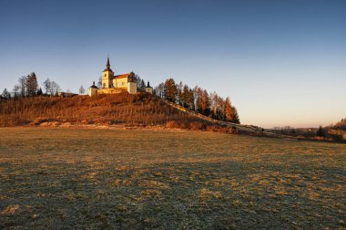 Homole, Czech republic - March 16 2025: Old place of pilgrimage Homole in Eastern Bohemia, long stone stairs with statues leading to the church, Czech Republic. Early spring sunny morning.