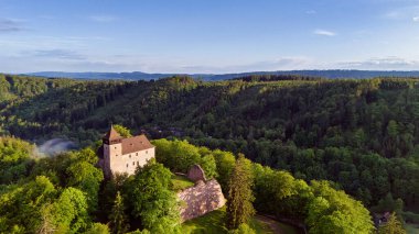 Tarihsel şato Litice, Bohemya, Çek Cumhuriyeti 'nin ormandaki büyülü günbatımı. Havadan ilkbahar görünümü.