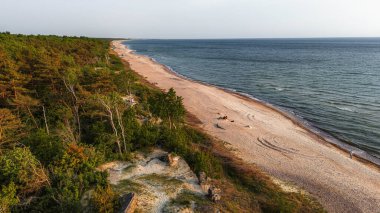 Klaipeda, Litvanya - 4 Haziran 2025: Memel Nord bataryasının insansız hava aracı fotoğrafçılığı - Yaz akşamı kıyı kenarında 2. Dünya Savaşı sığınağı.