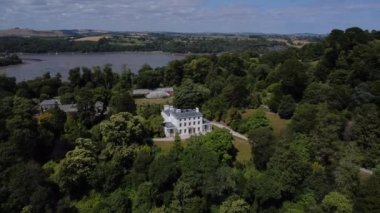 River Dart, Greenway, Güney Devon, İngiltere: DRONE ViEW: İnsansız hava aracı eskiden efsanevi suç yazarı ve edebiyat şahsiyeti Agatha Christie 'ye ait olan Greenway House ve bahçelerinden yavaşça uzaklaşıyor.).