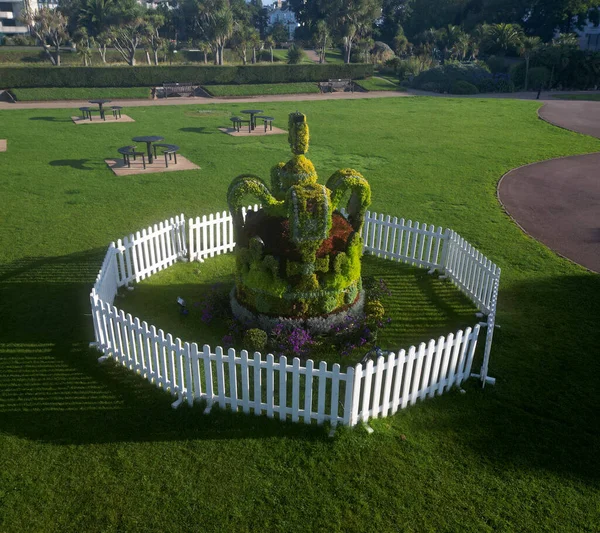 Torquay, Torbay, S. Devon, England: DRONE VIEW: A Topiary Crown celebrates King Charles III\'s coronation on 6th May, 2023, after the death of his mother, Queen Elizabeth II, in 2022. The Topiary is located in Torre Abbey Gardens, Torquay (PHOTO 1).