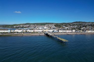 Teignmouth, South Devon, England: DRONE VIEW: The Grand Pier, the town of Teignmouth and the River Teign in the background. Teignmouth is both a port town and a popular English holiday destination (PHOTO 2). clipart