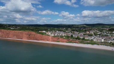 Budleigh Salterton, Doğu Devon, İngiltere: DRONE VİEWS: Dünya Mirası Sahası 'nın bir kısmını oluşturan kırmızı kumtaşı uçurumları ve Budleigh Salterton kasabası. Jurassic Coast popüler bir İngiltere turizm merkezidir (Clip 4).