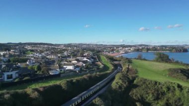 Oyster Cove, Torbay, Güney Devon, İngiltere: DRone VieWS: Oyster Bend köprüsünün altındaki Kingswear 'den Paignton' a giden bir buhar treni. Torbay, birçok farklı turizm merkeziyle popüler bir İngiltere tatil beldesidir (Clip 2).