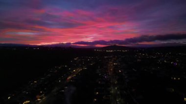 Paignton, Torbay, Devon, İngiltere: DRONE VİEWS: Paignton kasabasının banliyö bölgesinde kalan bulutları aydınlatan kırmızı bir günbatımı. Paignton, Güney Devon sahilinde bulunan popüler bir İngiltere tatil beldesidir.).