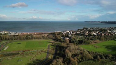 Paignton, Torbay, South Devon, England: DRONE VIEW: A view of Torbay Velopark and a golf practice course with the sea of Torbay and Berry Head in the background. Torbay is a popular UK holiday destination with a wide variety of visitor attractions. clipart