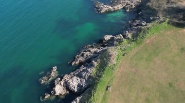 Broadsands, Torbay, South Devon, England: DRONE VIEWS: The drone spirals and ascends over coastal cliffs and parkland. South Devon is a popular UK holiday destination owing to its renowned coastline.