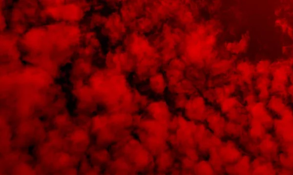 Siyah arkaplanda soyut kırmızı duman. Dramatik duman bulutları. Renkli dumanların hareketi. Kara zeminde izole bir şekilde patlayan barutun dondurucu hareketi..