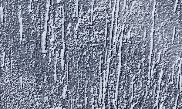 Abstract paint is peeling off the building wall.Close-up. Badly fixed building facade wall covered with cracks in stucco and paint. Missing patch of paint in the middle; crack with flappy.Wall texture with scratches and cracks.Seamless gray concrete.