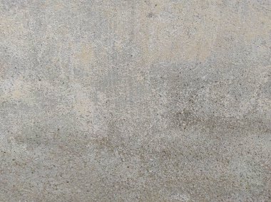 Soyut Taş Duvar arka plan, çimento efektli taşralı mermer dokusu, gri renk desenli doğal mermer figür, kum desenli. Geniş kaba beton duvar dokusu. Boş sert çimento yüzeyinin arka planı. Duvardaki çizikler çatlaklar..