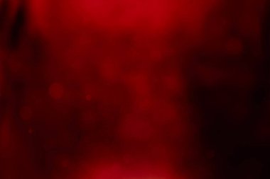 Kırmızı gradyanın soyut aydınlatıcı ışıltısı, arka plandaki bokeh simli duvar kağıdını büyülüyor..