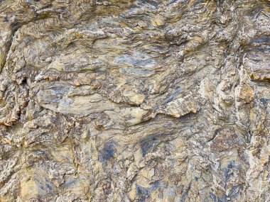 Doğal kaya yüzeyinin, pürüzlü, pürüzsüz, pürüzlü, pürüzlü arkaplan dokusuyla yakın görüntüsünü al.. 