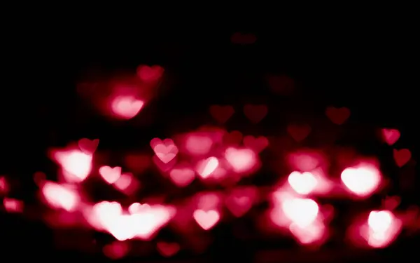 Sevgililer Günü arkaplanında pembe bir parıltı var. Sihirli ışık bokeh arkaplanını bulanıklaştırdı. 
