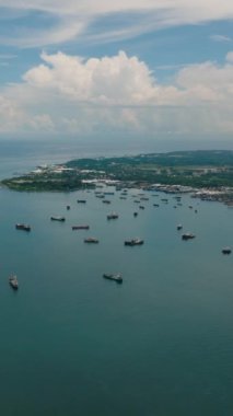 Costal sea bay with ship and boats in Zaboanga Peninsula. Mindanao, Philippines. Vertical video.