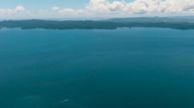 Open blue sea and tropical island. Seascape. Mindanao, Philippines.