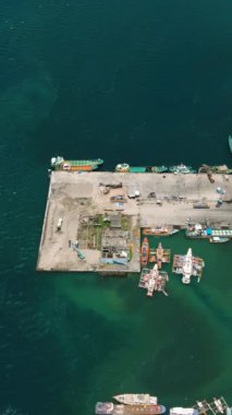 Colorful fishing boats in General Santos Fish Port. Mindanao, Philippines. Vertical view.