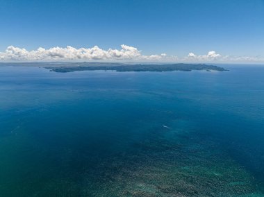 Open blue sea and tropical island. Seascape. Mindanao, Philippines.